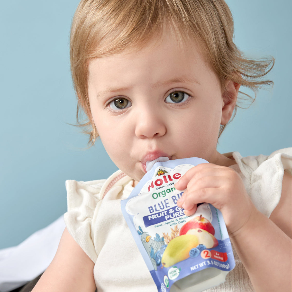 little girls eating blue bird pouch