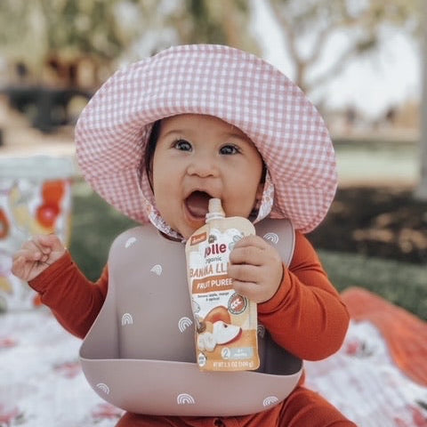toddler enjoying banana llama pouch