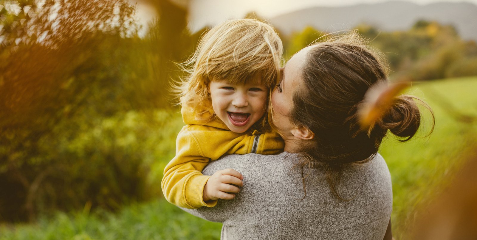 mom holding happy toddler